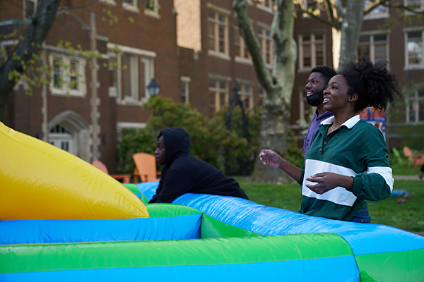 Three students playing a game at Spring Fest on the Hansen Quad.