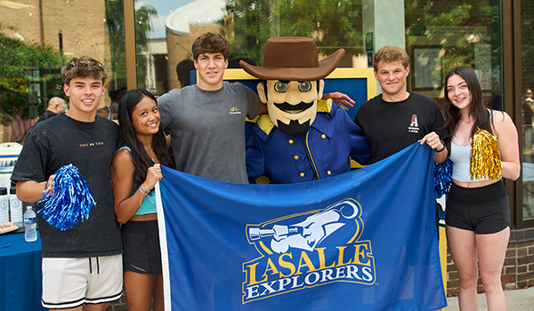 Image of five La Salle students posing for a photo with the Explorer.