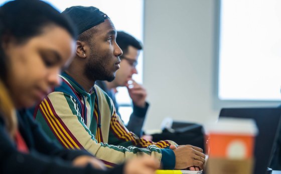 students sitting in a row of a classroom