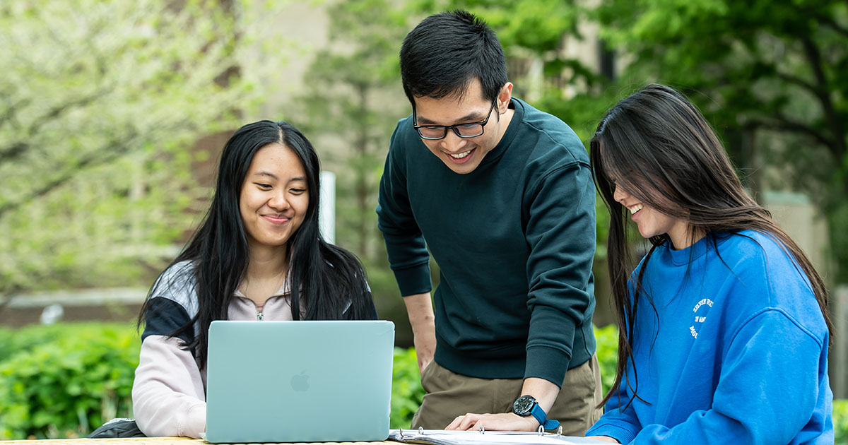 three students sitting at a table