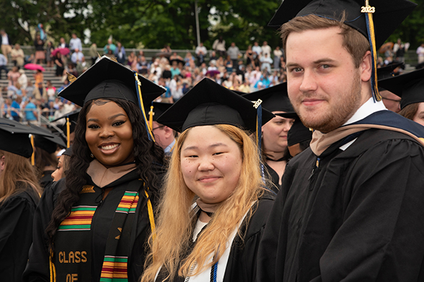 Image of three graduates. 