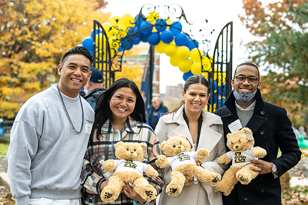 Four alumni holding La Salle bears.