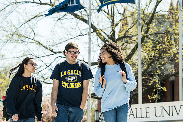 Image of three students walking around La Salle's campus.