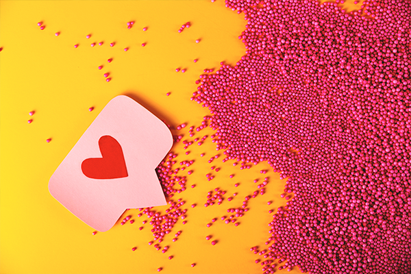 A heart emoji surrounded by pink decorations.