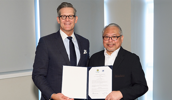 Left to right: La Salle President Daniel J. Allen, Ph.D., and De La Salle Medical and Health Sciences Institute President Antonio Ramos, M.D., present the signed MOU.