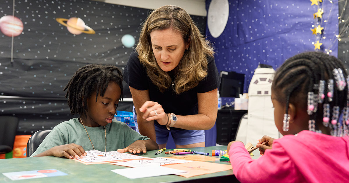 A La Salle graduate education student teaching local school students during STEAM Camp.