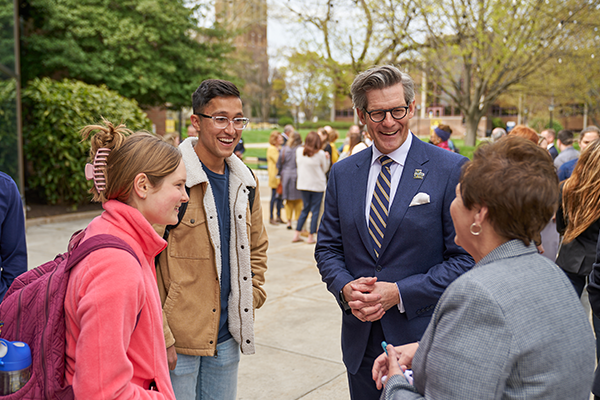 President Allen speaking with students and faculty.