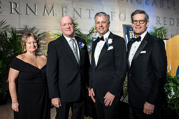 Image of President Allen, Ellen Reilly, ’83, Trustee E.F. (Bud) Hansen, III, ’90, MBA ’96, and  Dave Rowan.