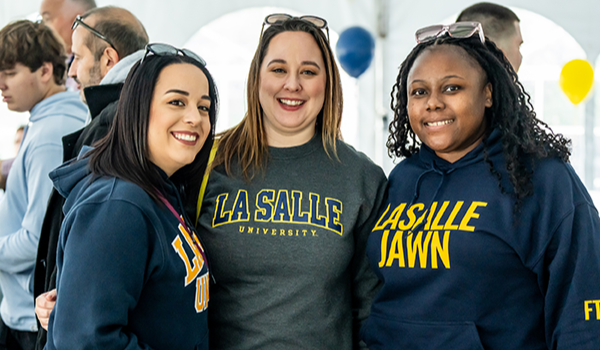 Image of six alumni at Homecoming.