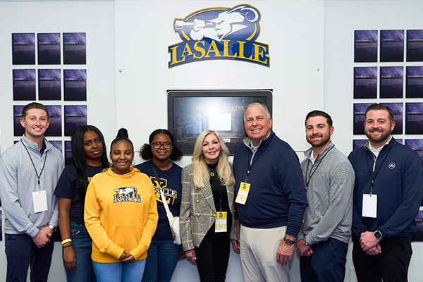 The Ciocca family (Cole Ciocca, far left, Sharon Ciocca, center left, Gregg Ciocca, center right, Gregg Ciocca Jr., right, Dylan Ciocca, far right) meet with students in La Salle’s LEAP program.