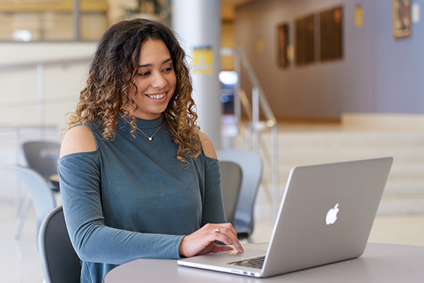 Image of a female student working on a computer.