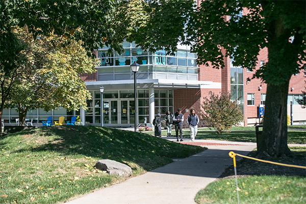Image of students walking outside of Holroyd Hall.