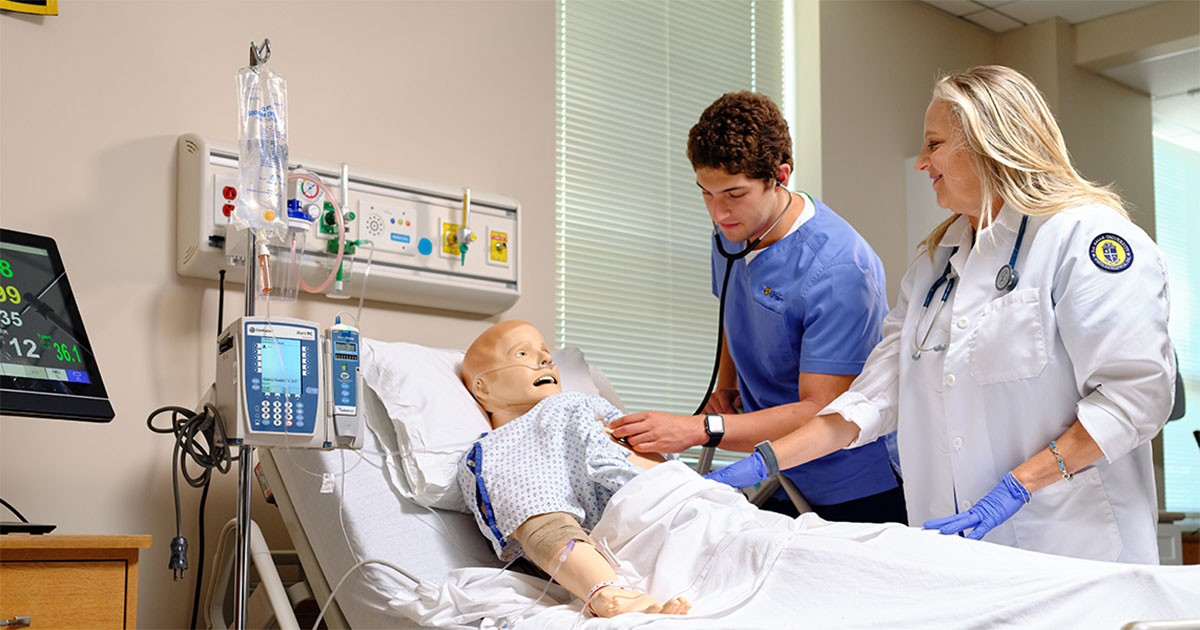 Image of a student and professor in the nursing simulation labs.