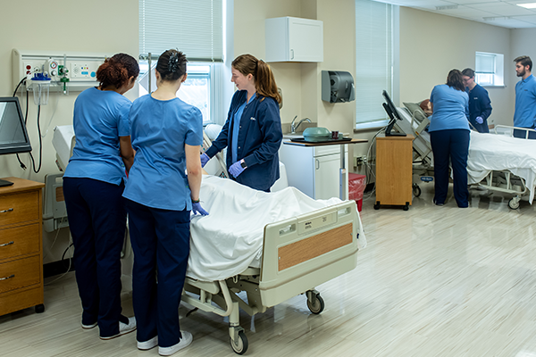 Image of students working in the nursing simulation labs. 