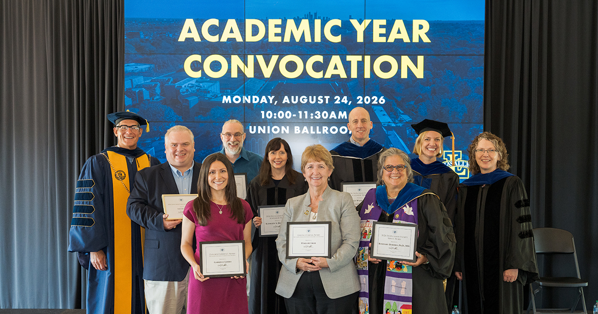Photo of faculty and staff posing with a...