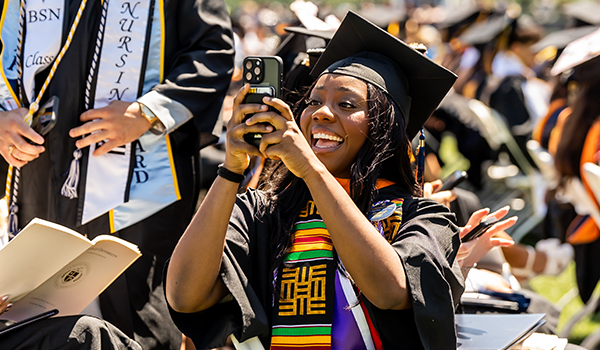 Image of a student taking a photo on her phone