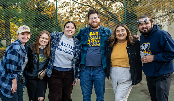 Image of six alumni at Homecoming.