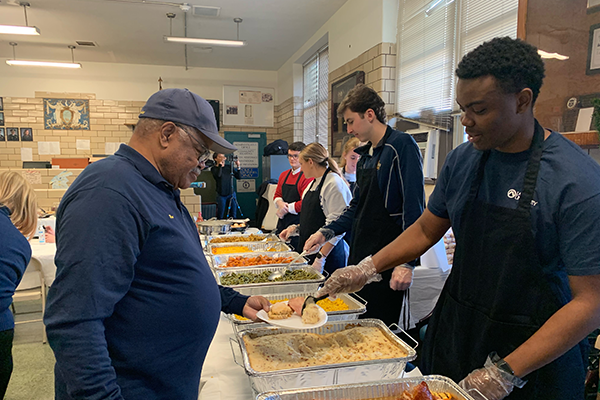 Students serving food for the Philadelphia Police. 