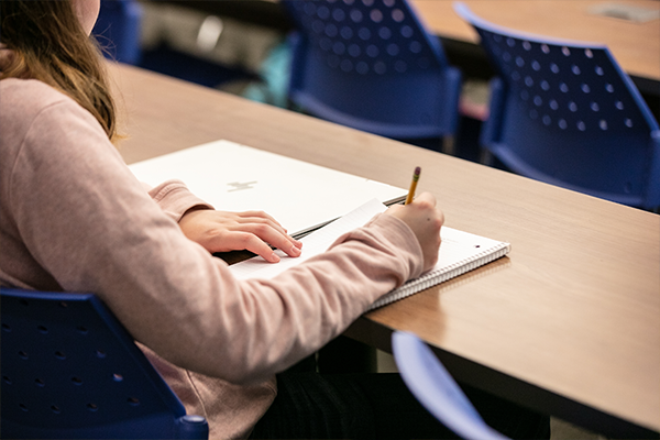 Image of a student writing. 