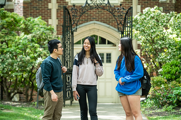 Image of three students walking on the Hansen Quad.