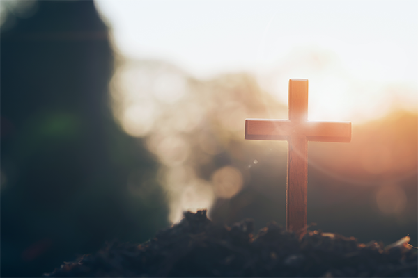 Background image of a cross and sunlight.