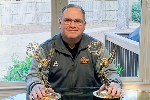 Albert “Scooter” Vertino, ’93, poses with his most recent Emmy Award statuettes in his home in Georgia.