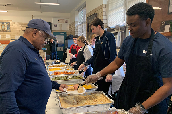 Image of students serving food to the Philadelphia Police Department.