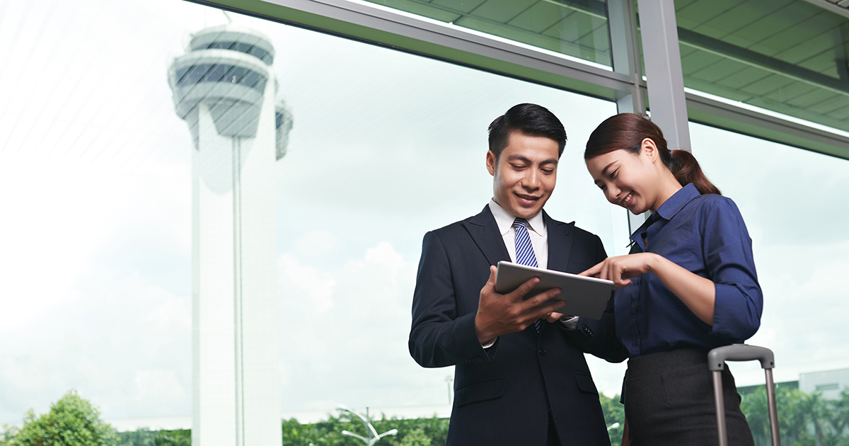 Image of two aviation professionals at an airport. 