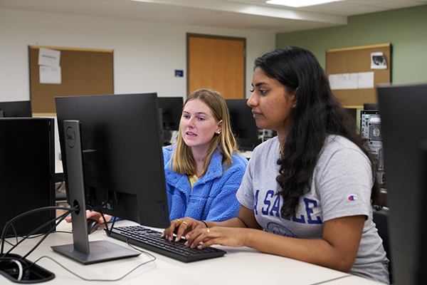 Two students working in the computer lab.