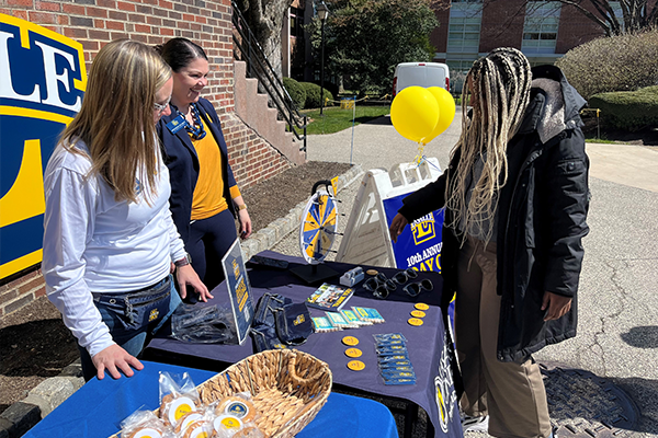 Image of a student at a giving station outside the Lawrence Administrative Building.