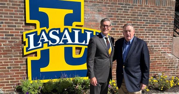 President Allen standing together with William M. Nolte by the La Salle Legacy Sign