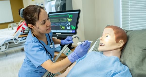 Nursing student practicing on sim dummy